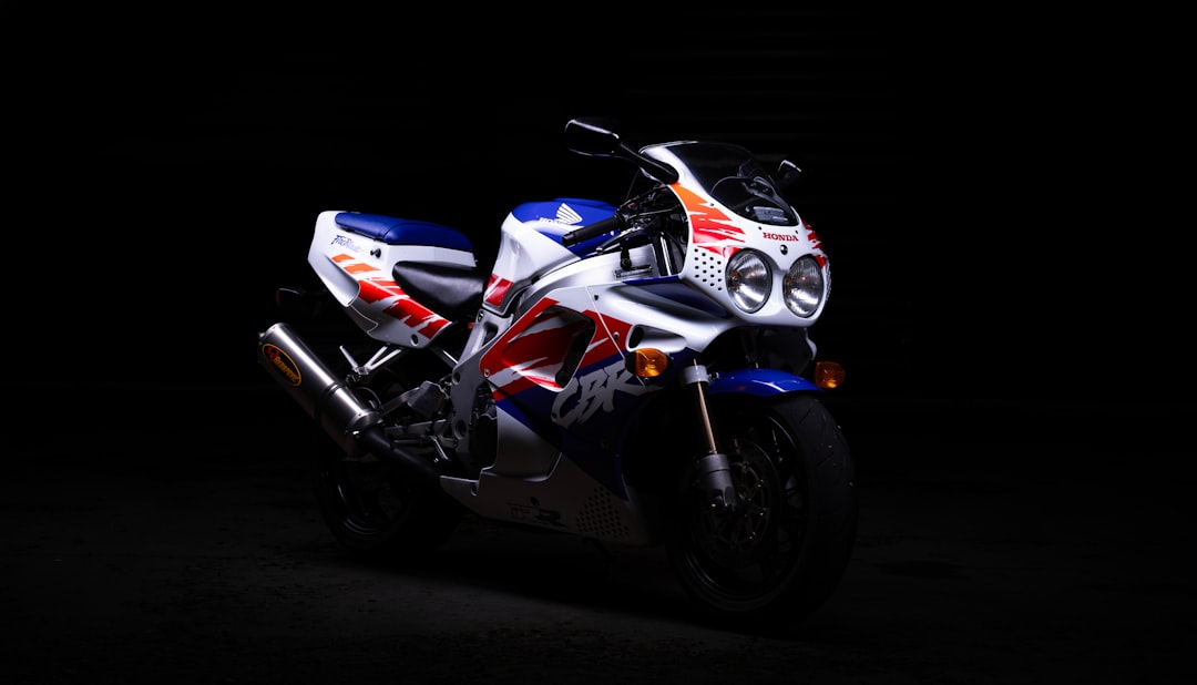 a-white-and-blue-motorcycle-parked-in-the-dark-vtc0yic-2fy